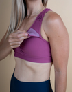 Mum wearing pink breastfeeding sports bra with dropdown cup unclipped