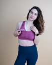 front view of a pink breastfeeding sports bra with dropdown cup unclipped