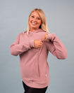 Active mama showing the nursing zip function on maternity sweatshirt with hood