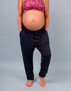 front view of a fit pregnant mother wearing navy bamboo jogger pants