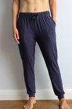 front view of a fit mother wearing navy bamboo jogger pants