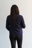 Back view of pregnant mother wearing navy breastfeeding crew neck jumper