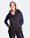 Happy, pregnant mother wearing a women's black puffer vest
