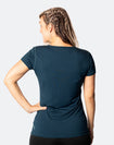 Back view of happy, fit mum wearing Cadenshae Workout tee in peacock
