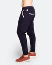 Side view of navy blue postpartum lifestyle pants with white floral detailing on pocket