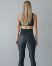 Back view of black high waisted maternity leggings with pockets