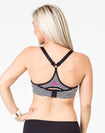 back view of a black and white striped maternity activewear bra with a racerback and Cadenshae logo