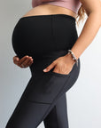 Pregnant mother wearing high waisted maternity leggings in black